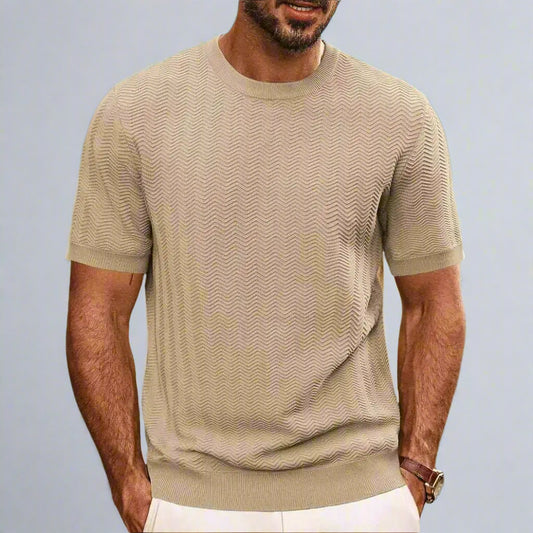 Man wearing a beige textured t-shirt on a beach