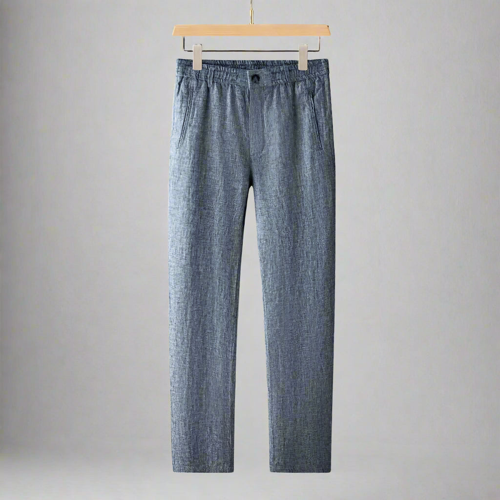 Blue checkered pants on a hanger against a gray background