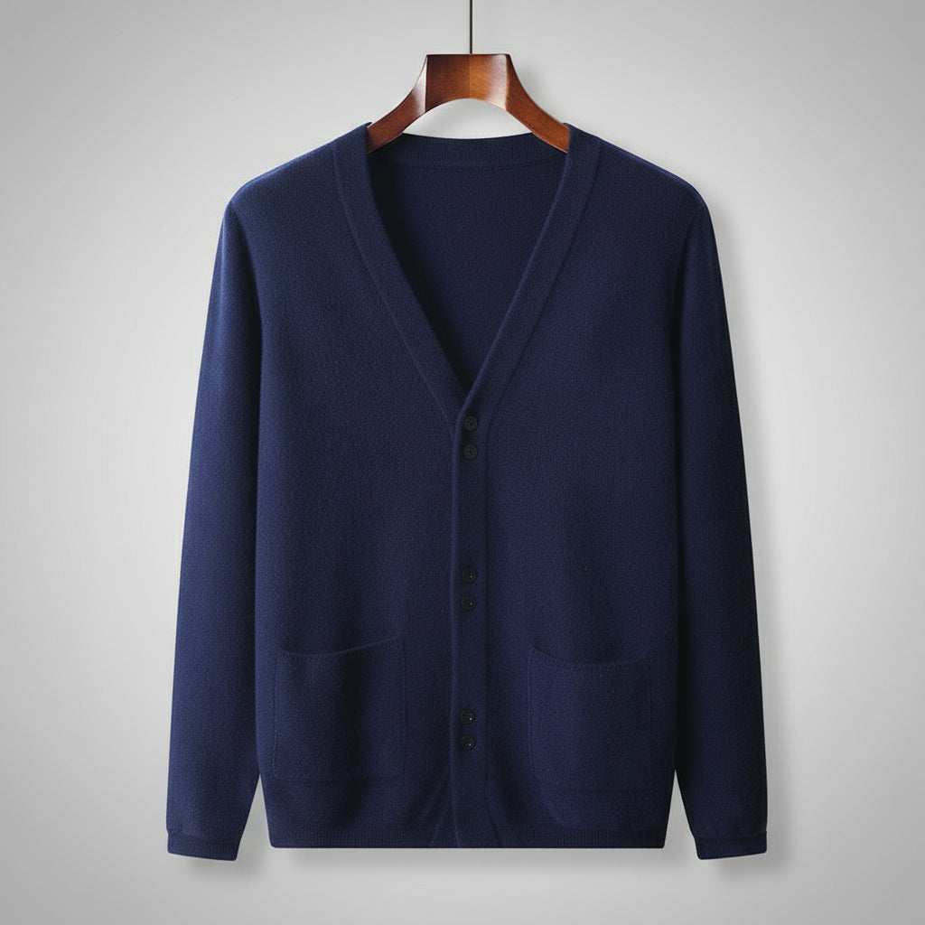 Navy blue cardigan on a wooden hanger against a gray background