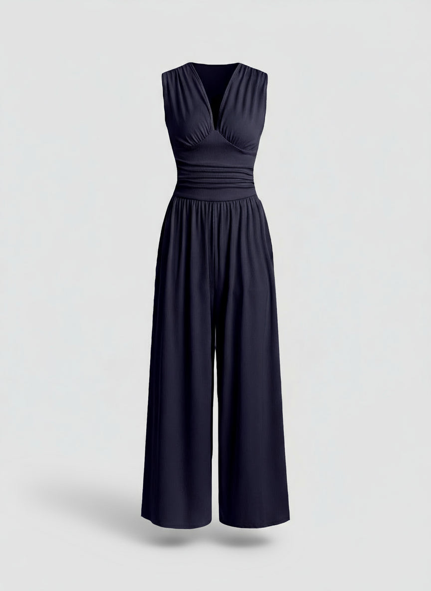 Navy blue jumpsuit on a light gray background
