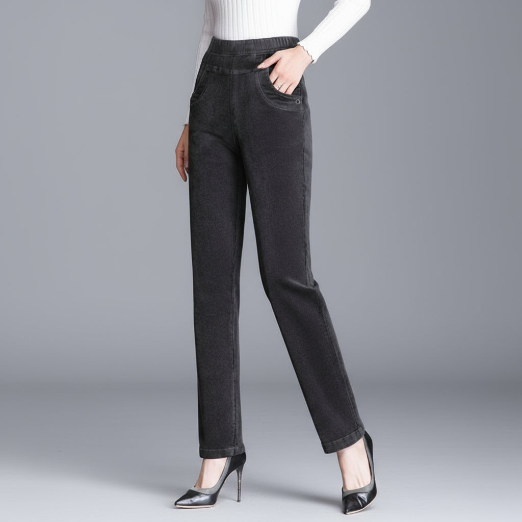 Person wearing dark gray pants on a gray background