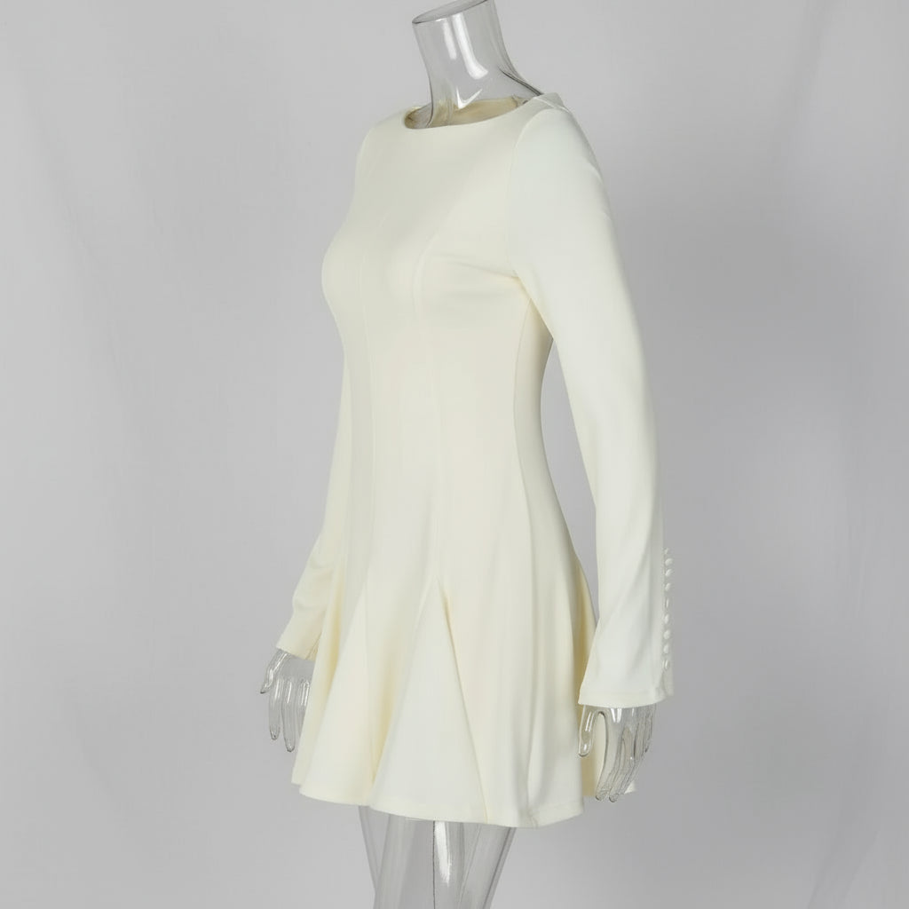 White dress with fringe details on a white background