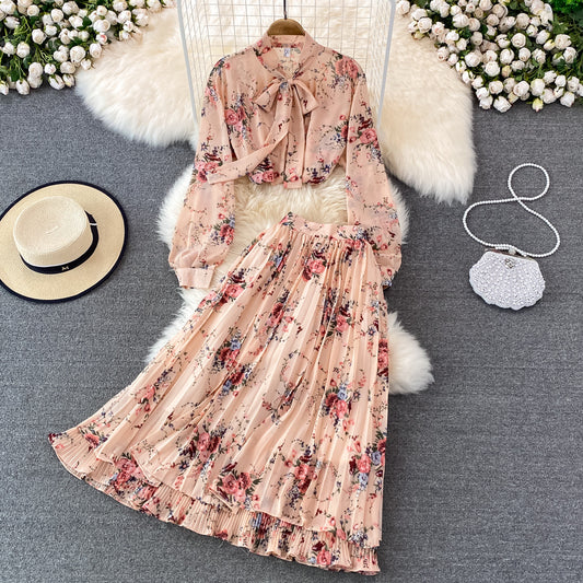 Floral dress with matching top on a gray surface with decorative items.