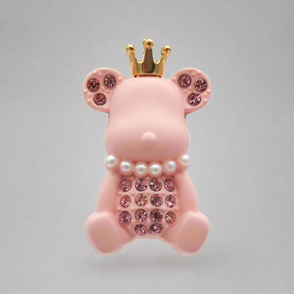 Pink piggy bank with a gold crown and decorative elements on a white background