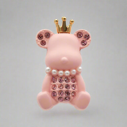 Pink piggy bank with a gold crown and decorative elements on a white background
