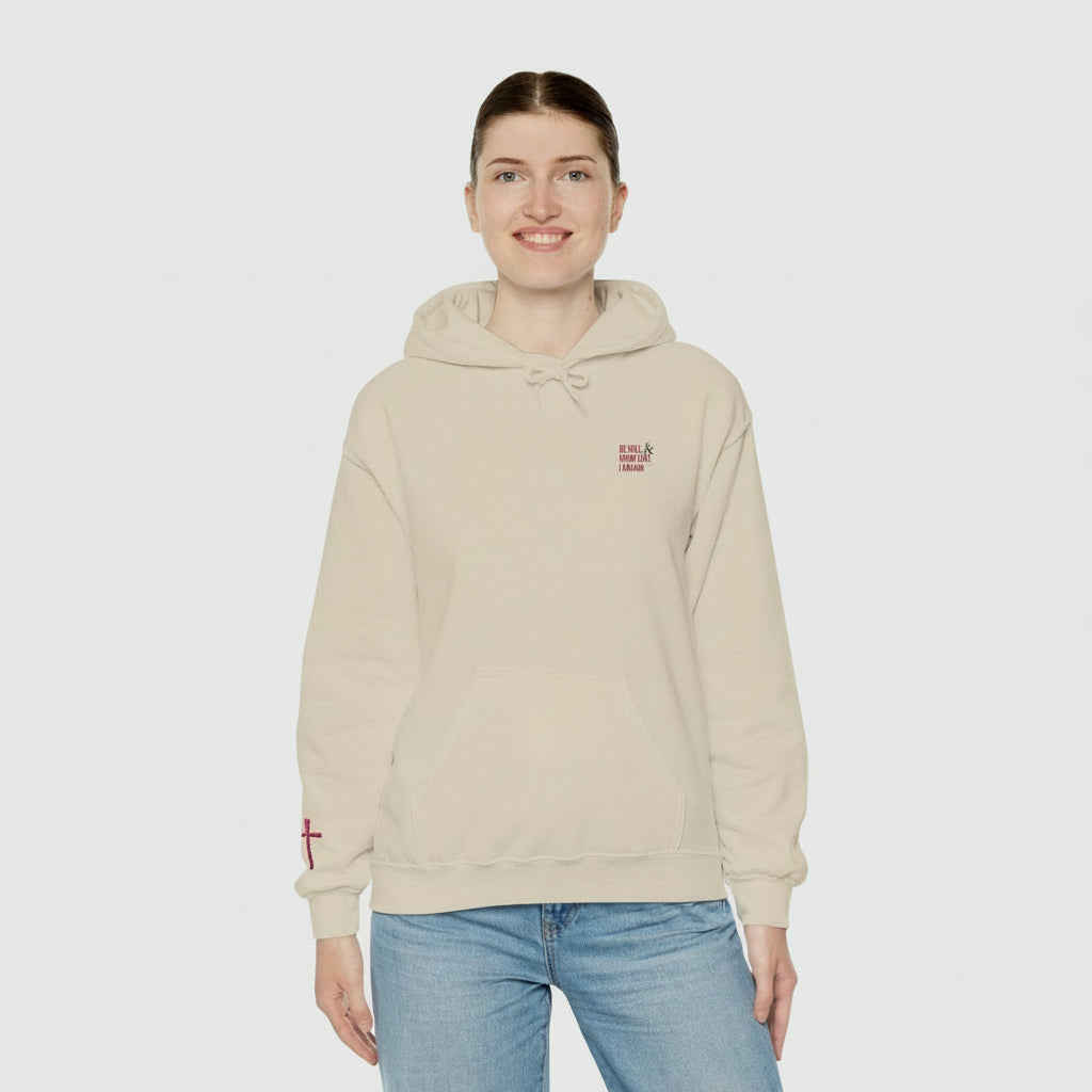Person wearing a beige hoodie with a logo on a white background
