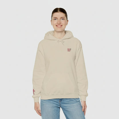 Person wearing a beige hoodie with a logo on a white background
