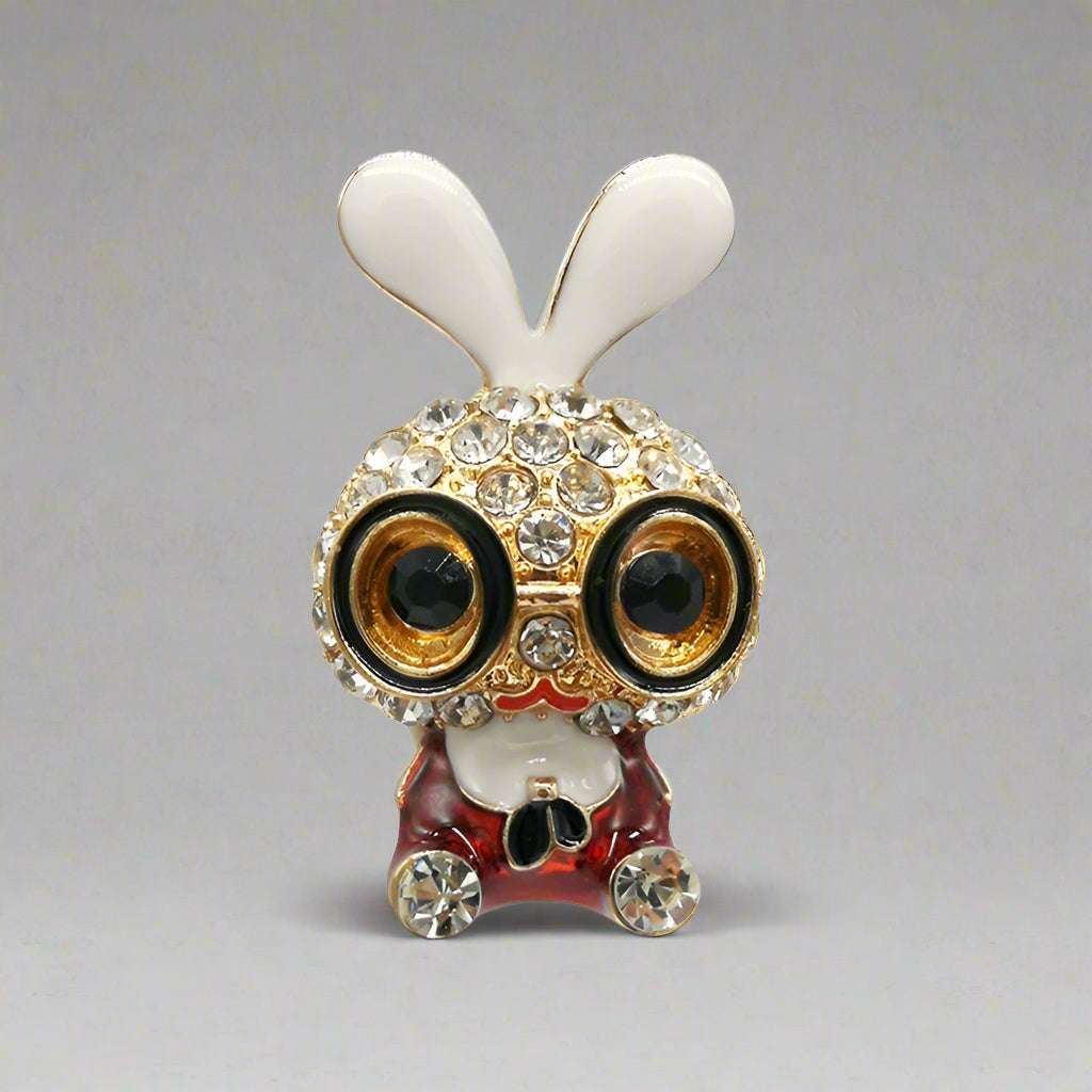 Decorative owl figurine with white ears and rhinestone embellishments on a white background