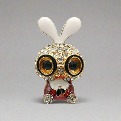 Decorative owl figurine with white ears and rhinestone embellishments on a white background