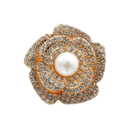Jewelry brooch with pearl and rhinestones on a white background