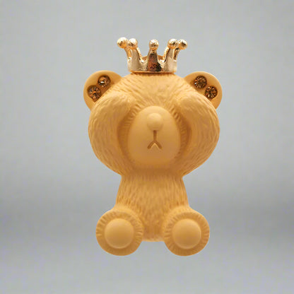 Yellow teddy bear with a gold crown on a white background