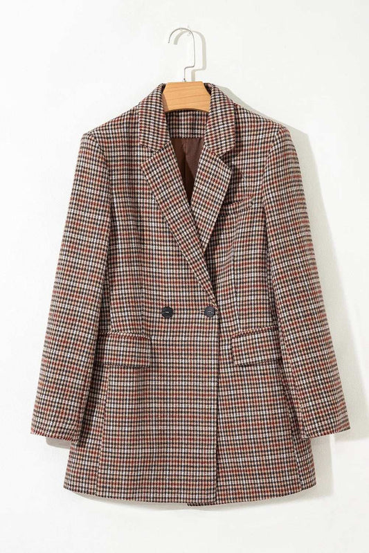 Plaid blazer on a hanger against a white background