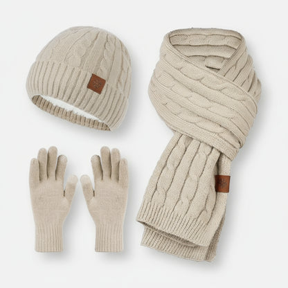 A set of women's knitted hat, scarf, and gloves in beige color, displayed on a white background.