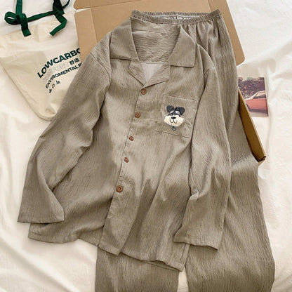 Beige pajama set with a dog patch on a white surface