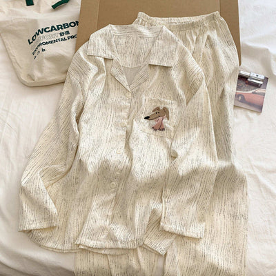 Beige pajama set with a small dog design on a white surface