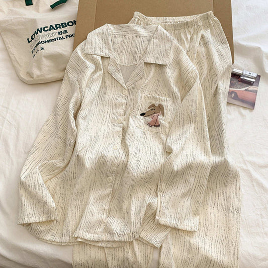 Beige pajama set with a small dog design on a white surface