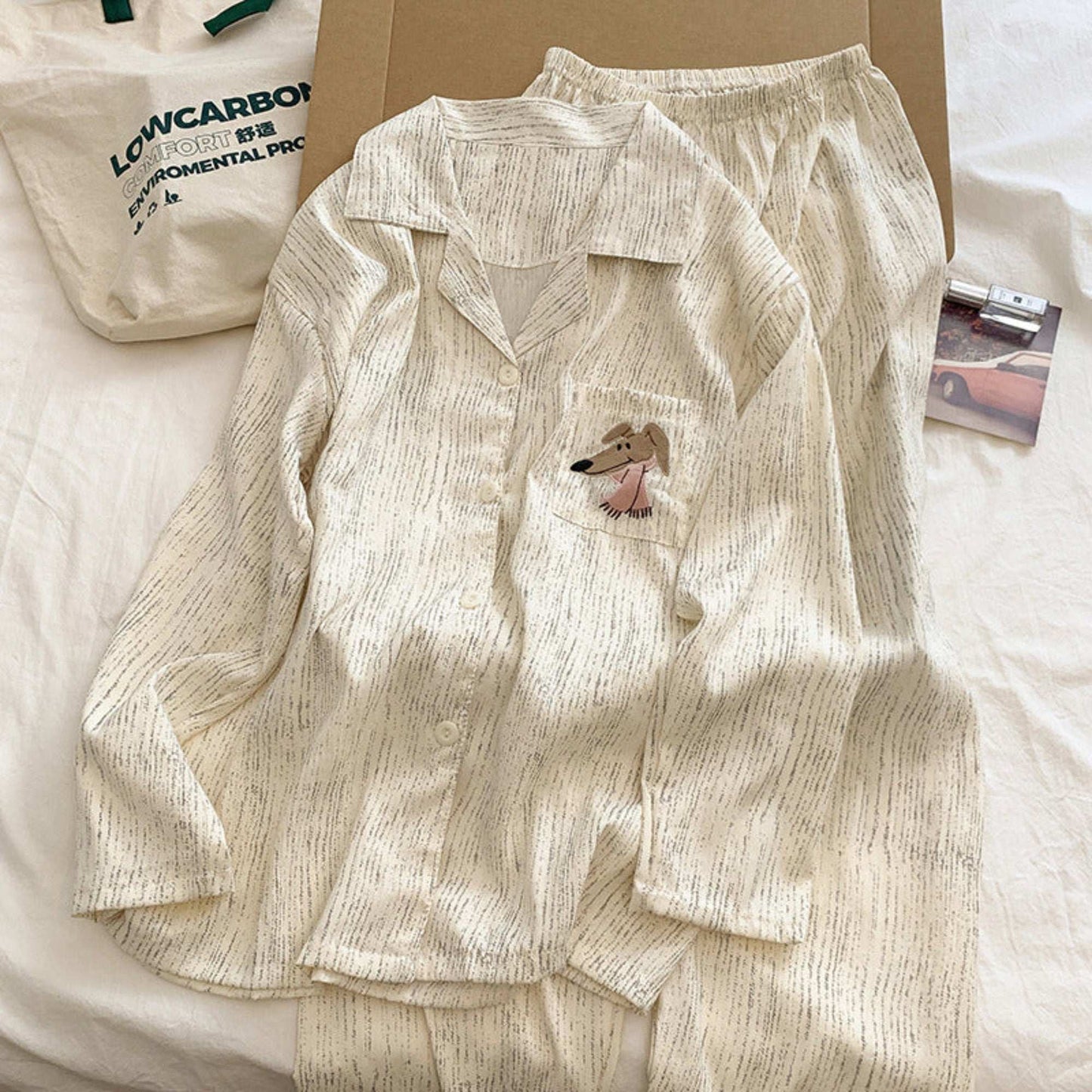 Beige pajama set with a small dog design on a white surface