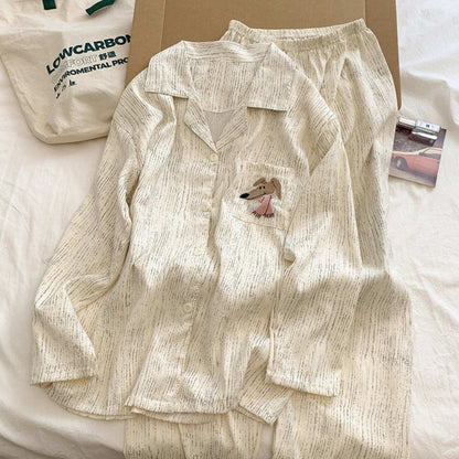 Beige pajama set with a small dog design on a white surface