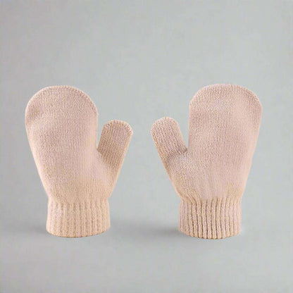 Pair of beige mittens on a gray background