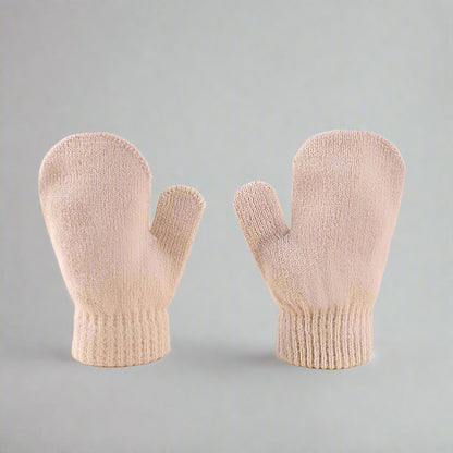 Pair of beige mittens on a gray background