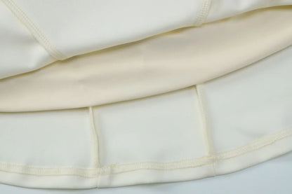 Close-up of a white garment with a gold trim on a light gray background