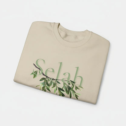 Folded beige sweatshirt with 'Selah' and olive branch design on a white background