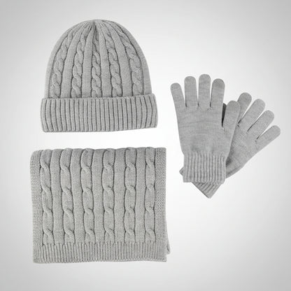 Gray knit hat, scarf, and gloves set on a light gray background