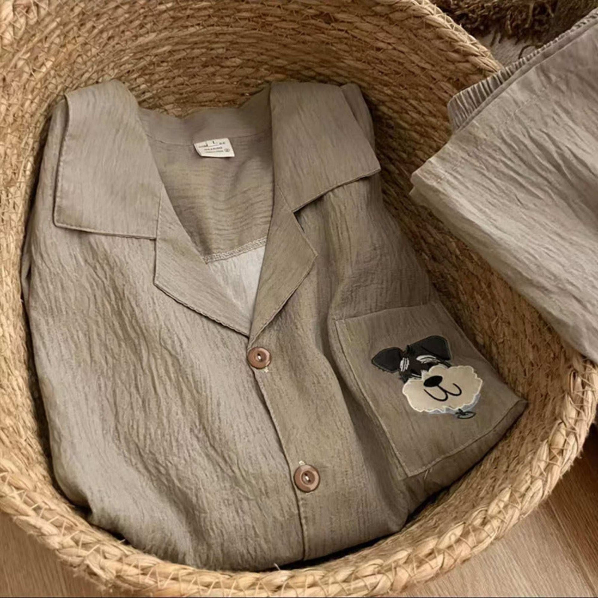 Light brown shirt with a patch on a woven surface