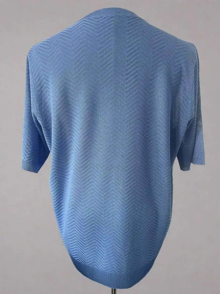 Blue knitted sweater on a mannequin against a gray background