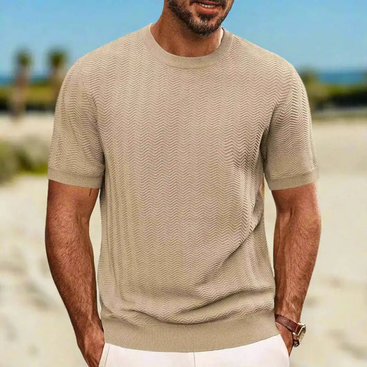 Man wearing a beige textured t-shirt on a beach