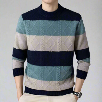 Person wearing a striped sweater with a dark gray background