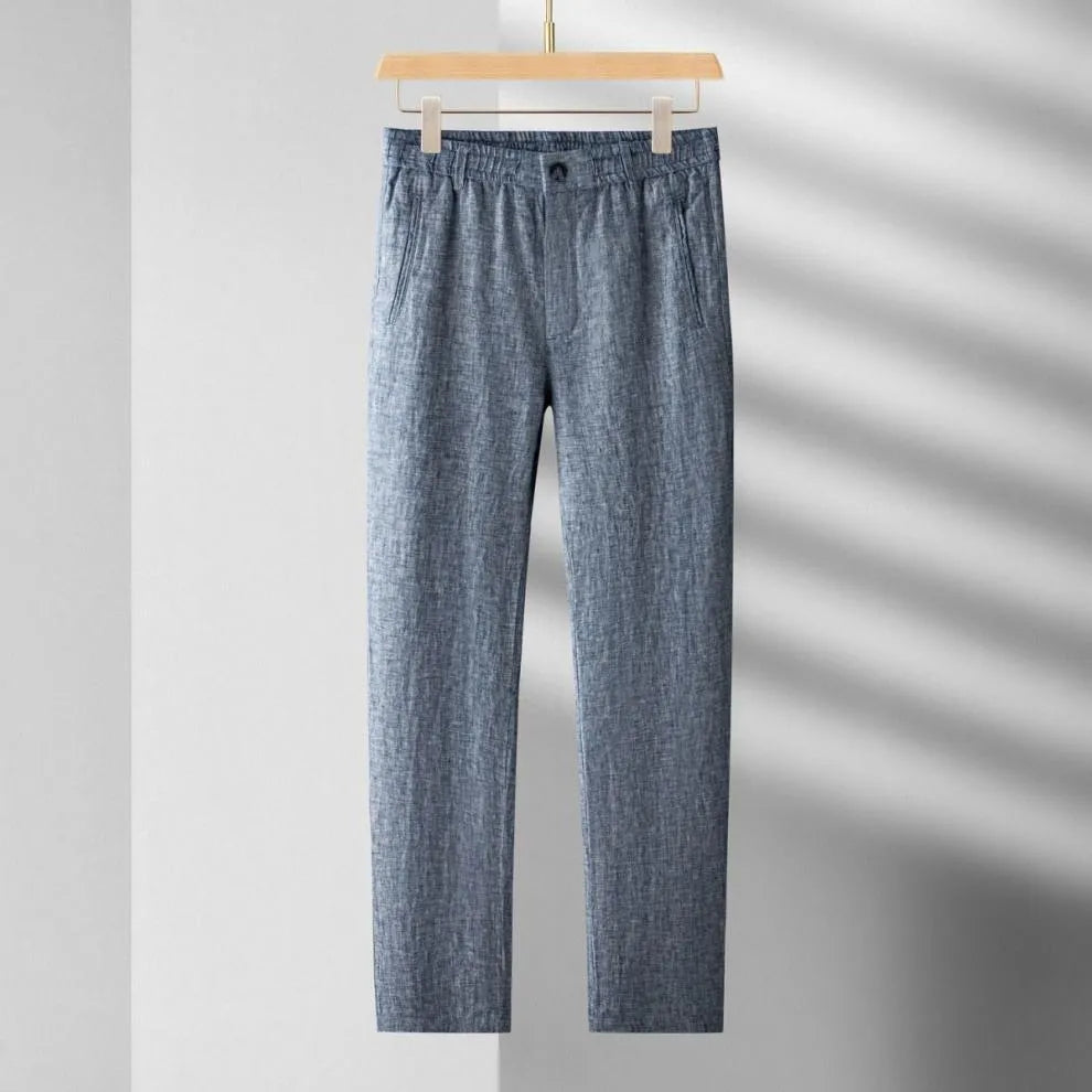 Blue checkered pants on a hanger against a gray background