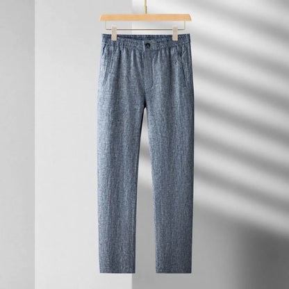 Blue checkered pants on a hanger against a gray background