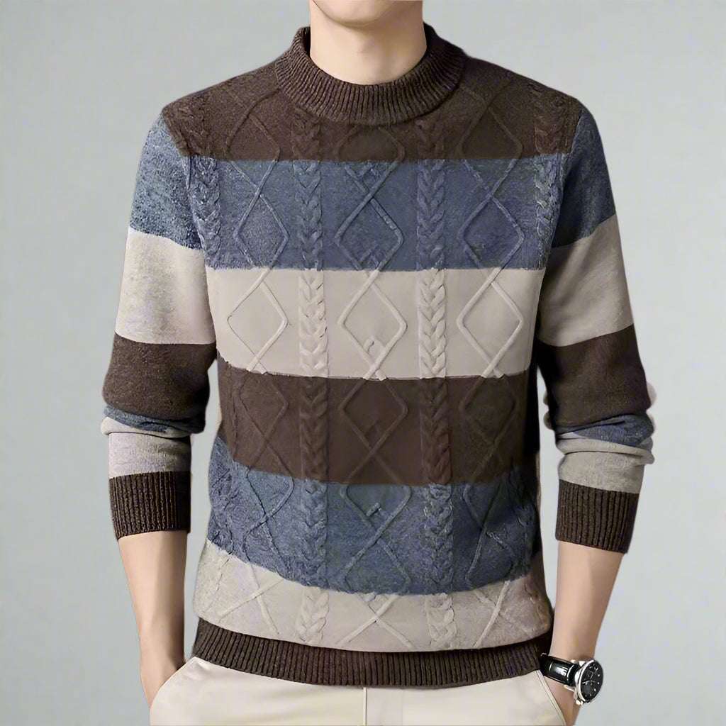 Multicolored patterned sweater worn by a person on a dark background