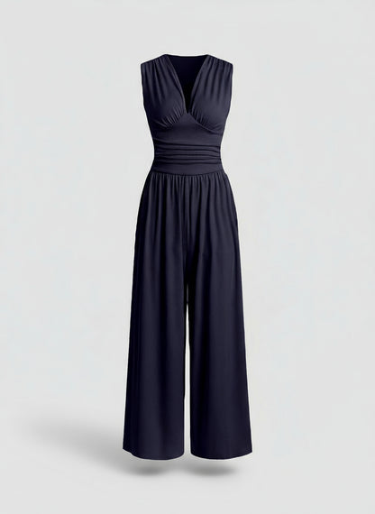 Navy blue jumpsuit on a light gray background
