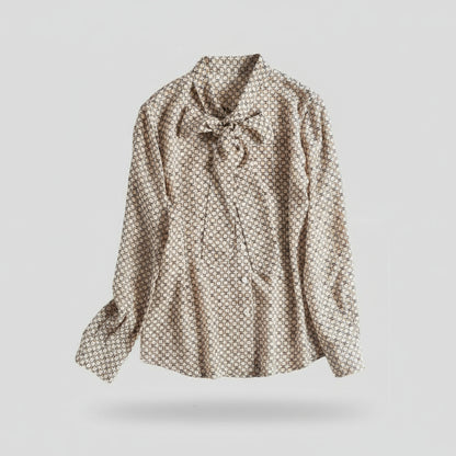 Patterned blouse with a bow tie on a white background