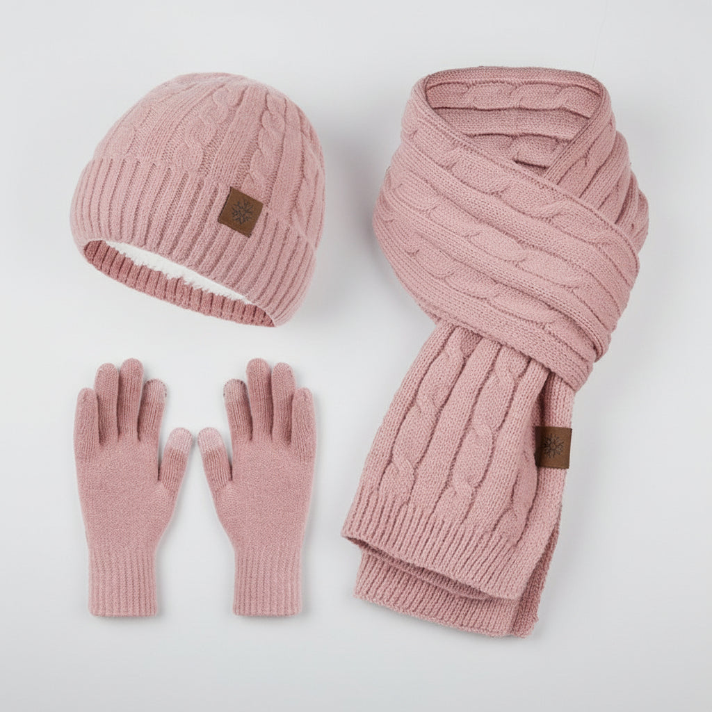 Pink knit hat, scarf, and gloves set on a light gray background