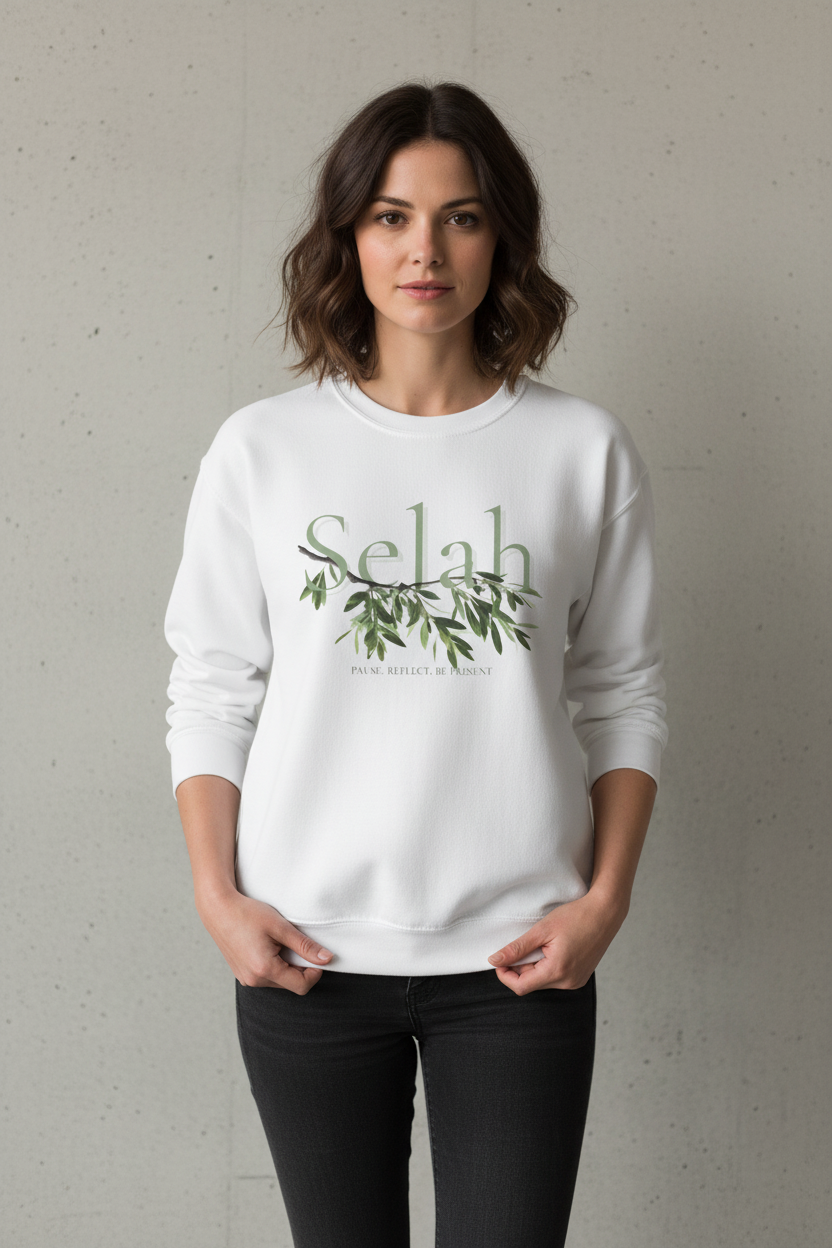 White sweatshirt with Selah and olive branch design on a female model