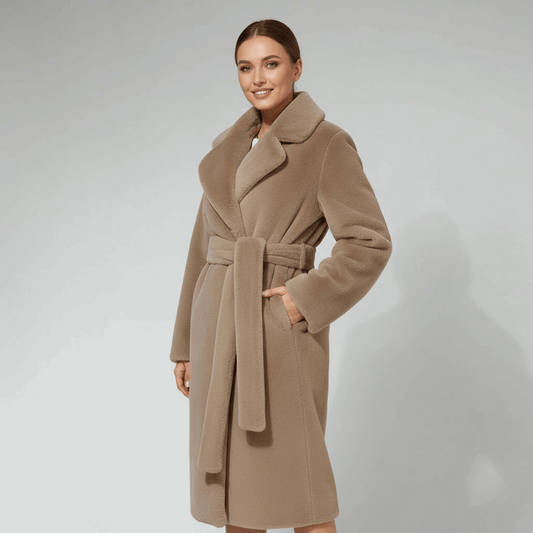 Woman wearing a beige coat on a plain background
