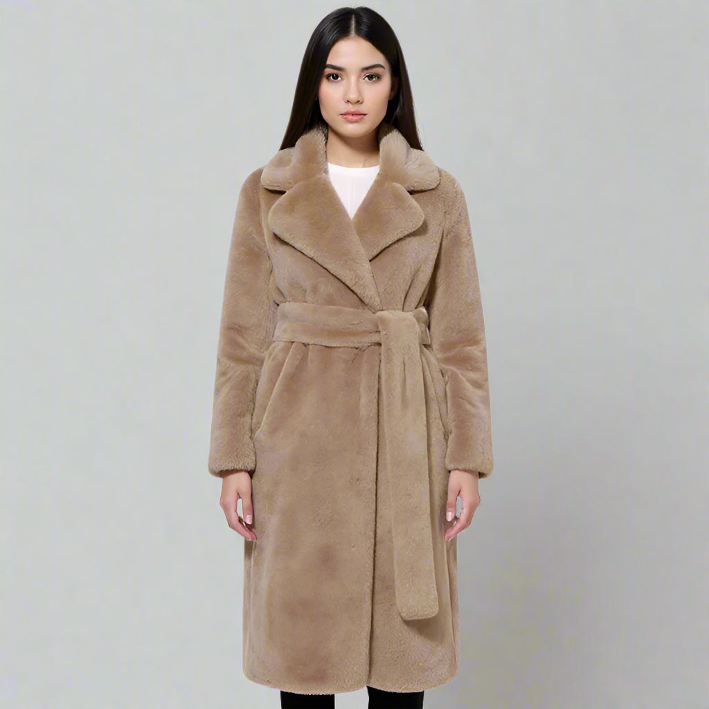 Woman wearing a beige coat on a white background