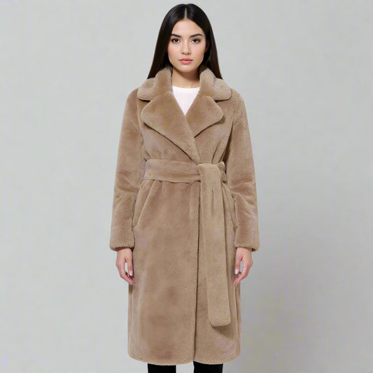 Woman wearing a beige coat on a white background