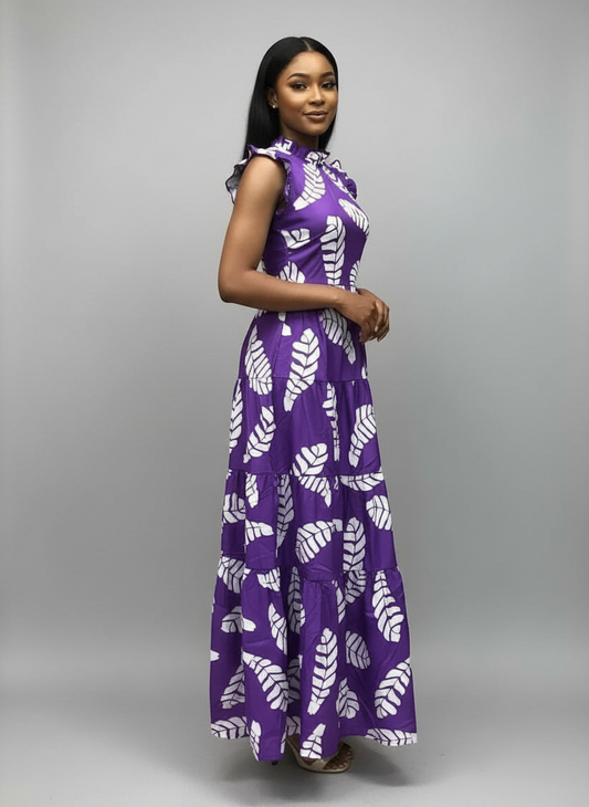 Woman wearing a purple and white patterned dress against a pink background