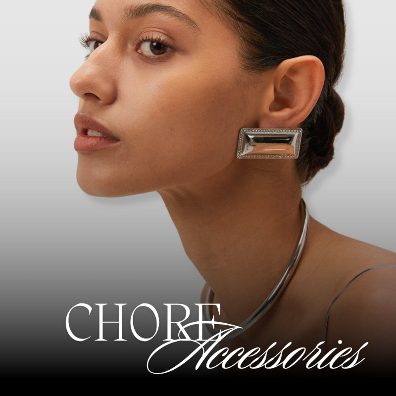 Woman wearing a rectangular earring with 'Chore Accessories' branding.