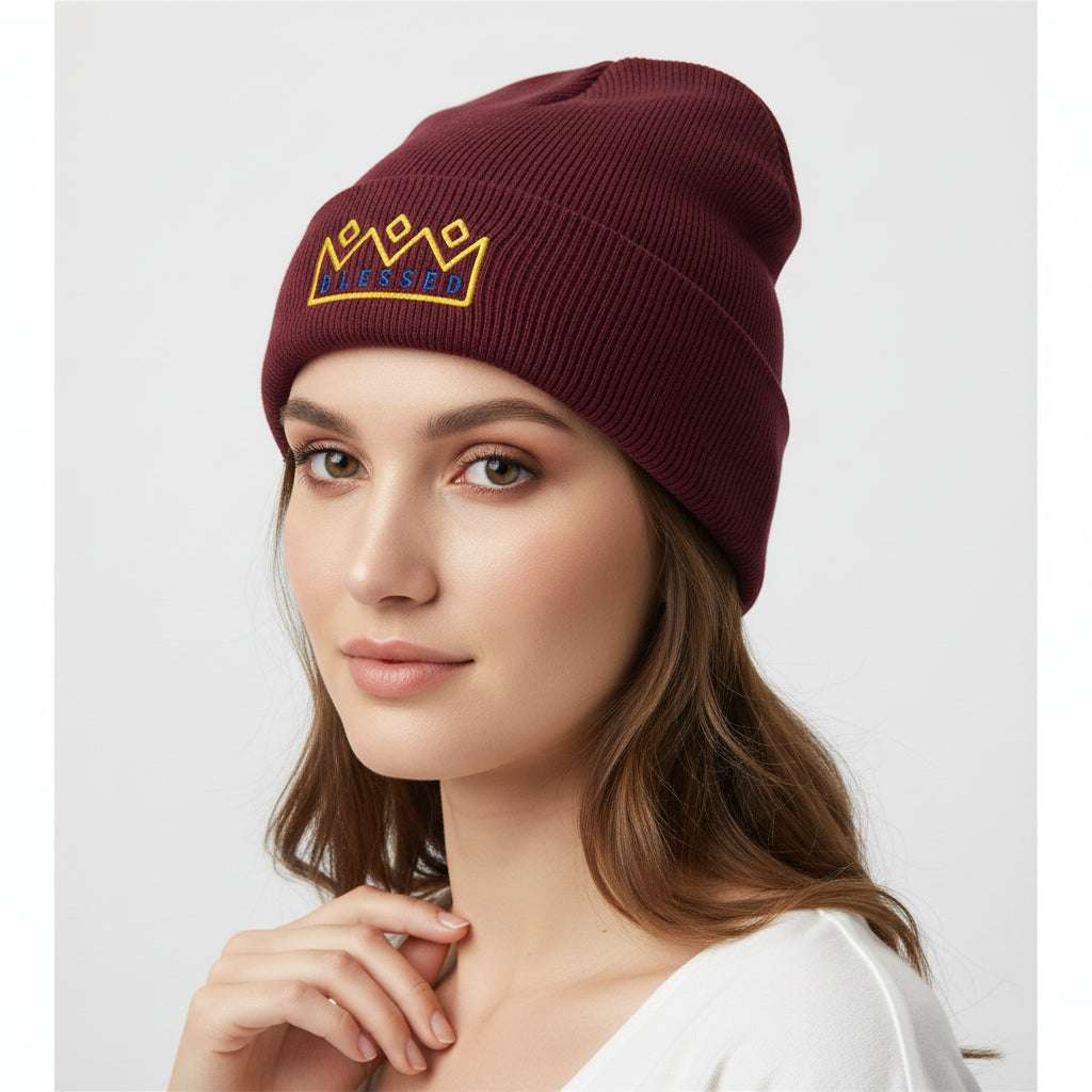 a woman wearing a Burgundy color beanie knit hat with an embroiled  text Blessed and a yellow crown